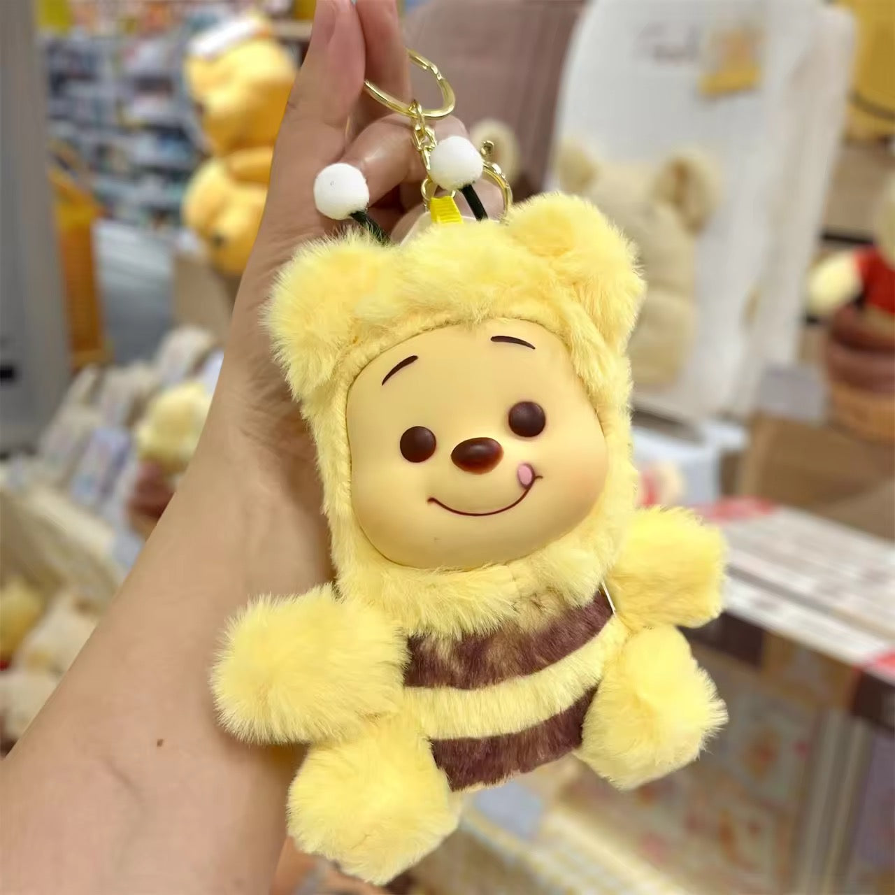 Winnie the Pooh keychain featuring a cute plush figure, attached to a silver keyring, from Kxh Official Store.