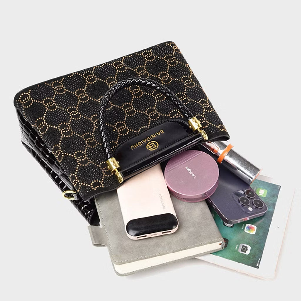 Geometric studded crossbody bag with structured design and metal accents, featuring a black leather look and adjustable strap.