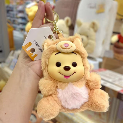 Winnie the Pooh keychain featuring a cute plush figure with a red shirt, attached to a metal keyring.