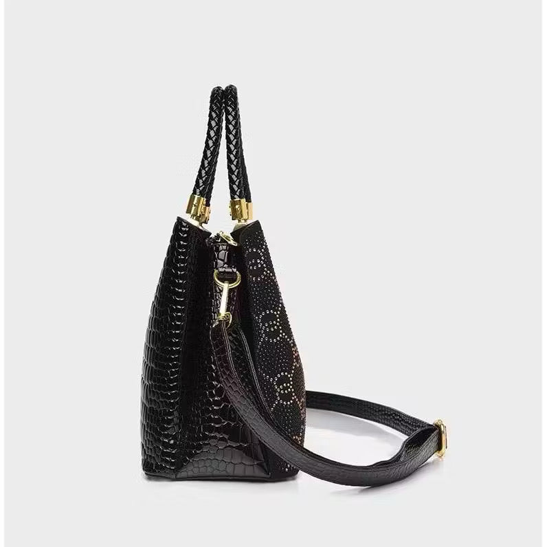 Geometric studded crossbody bag with bold design and hardware, featuring a compact silhouette and adjustable strap.