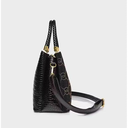 Geometric studded crossbody bag with bold design and hardware, featuring a compact silhouette and adjustable strap.