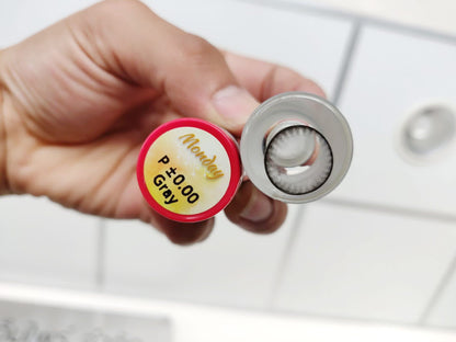 Close-up of clear contact lenses from Kxh Official Store, showing the lenses in a container against a white background.