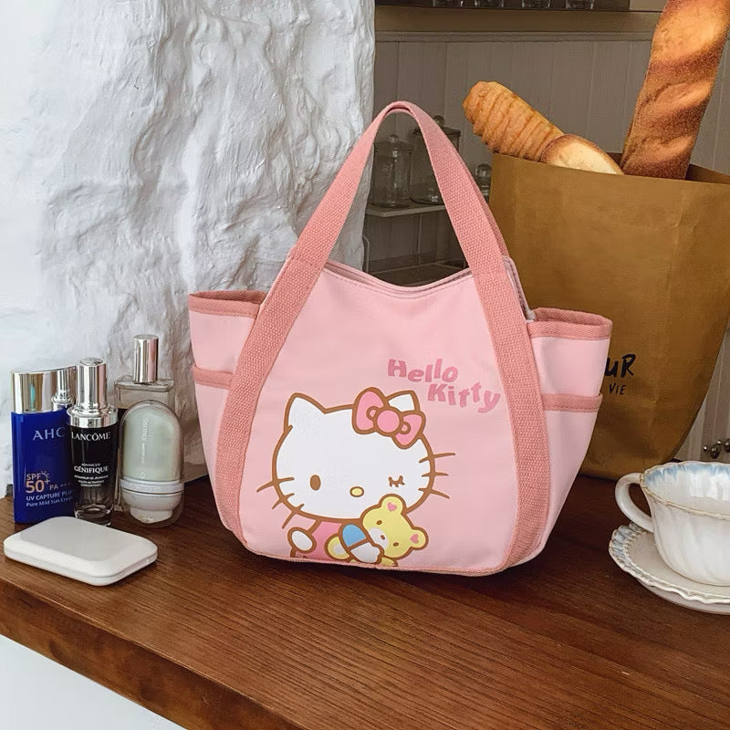 Pink Hello Kitty canvas mini tote bag with a cute Hello Kitty face and bow design, perfect for casual carrying.